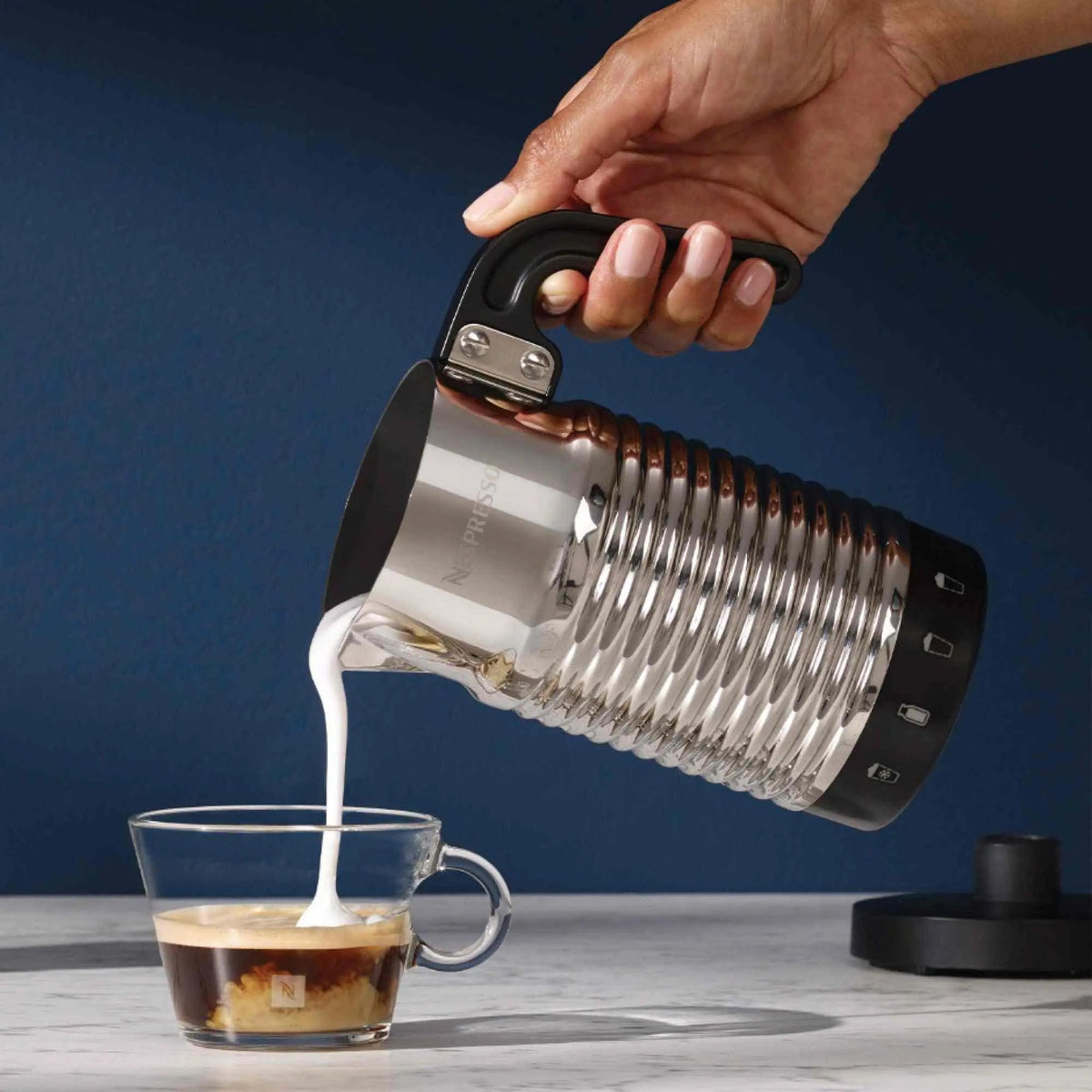 Nespresso Aeroccino 4 silver electric milk frother with ergonomic handle and sleek design on countertop
