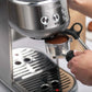 Breville Bambino Espresso Machine stainless steel compact countertop with steam wand and crema-topped espresso cup