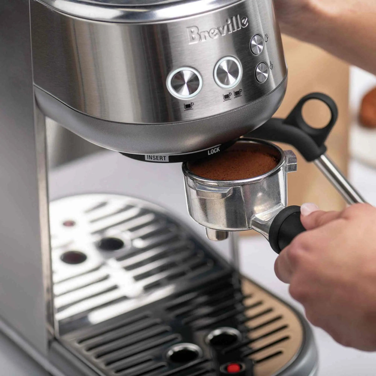 Breville Bambino Espresso Machine stainless steel compact countertop with steam wand and crema-topped espresso cup