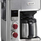 Wolf Gourmet automatic drip coffee maker with 10-cup capacity, stainless steel finish, and brewing carafe on a countertop.